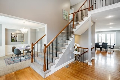 Huge entry way looking left at stairs and dining r