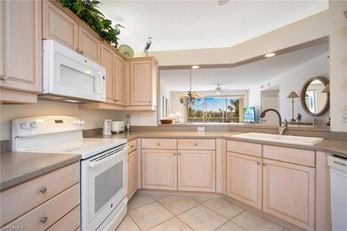 Kitchen featuring white appliances, light tile pat