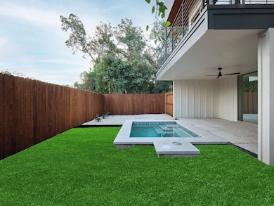 View of swimming pool featuring a patio, a balcony, ceiling fan, a fenced backyard, and an in-ground hot tub
