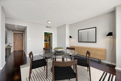 Dining area shown open to the entry and kitchen. I