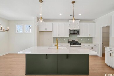 Kitchen featuring appliances with stainless steel finishes, decorative backsplash, light wood-type flooring, light countertops, and recessed lighting