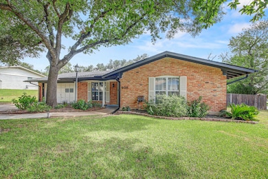 Ranch-style house with brick siding