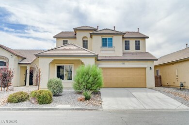 View of front of home with a garage, driveway, stu