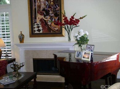 LIVING ROOM WITH MARBLE FIREPLACE