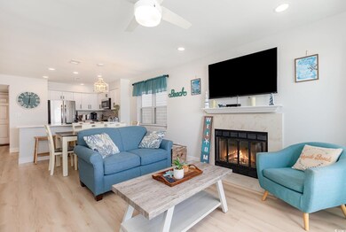 Living area with ceiling fan, a fireplace, light w