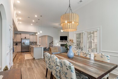 Dining space with ceiling fan with notable chandel