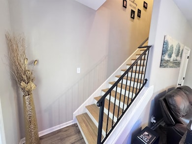 Stairs featuring wood finished floors