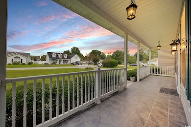 Patio terrace at dusk featuring covered porch and 