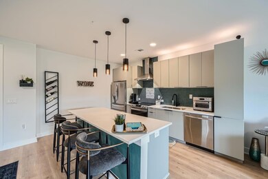 Kitchen with wall chimney range hood, appliances 