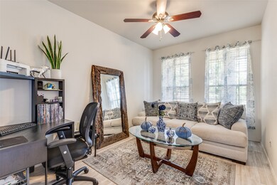 Office featuring wood finished floors, plenty of natural light, and ceiling fan