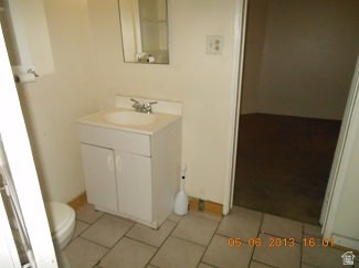 Half bathroom featuring light tile patterned floors and vanity