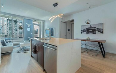 Kitchen featuring stainless steel dishwasher, lig