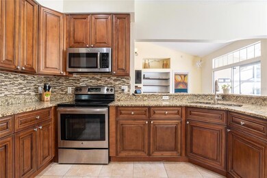 Beautifully updated kitchen looking into family room and towards master bedroom