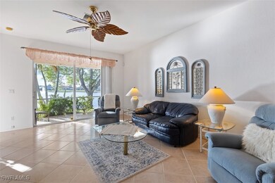 Living room with light tile flooring and ceiling f