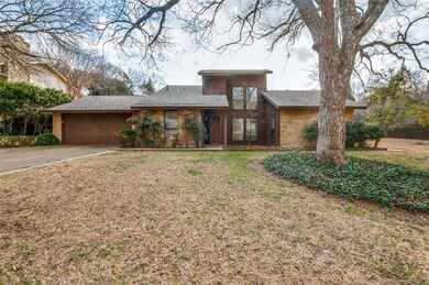 View of front facade with driveway, brick siding, 