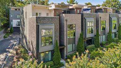 Welcome home to 728 Oakview, a fee simple end-unit townhome in the heart of Oakhurst Village