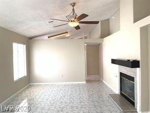 Unfurnished living room with a glass covered firep