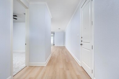Corridor featuring light wood-type flooring and c