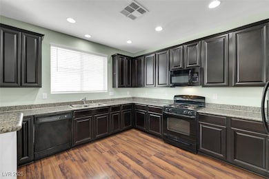 Kitchen featuring black appliances, recessed light