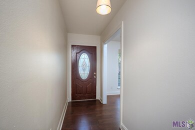 Wood floors in the foyer open to the homes living 