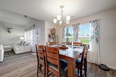 Dining area with a chandelier and wood finished f