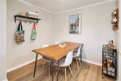 Dining space featuring baseboards, light wood-styl