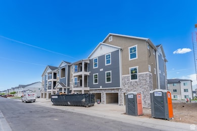 View of property featuring a garage and a residential view