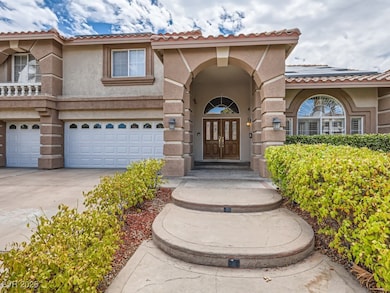 Property entrance featuring stucco siding, a tile roof, driveway, and a garage