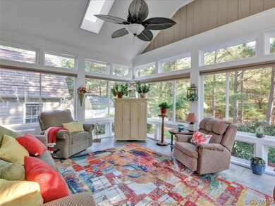 Gorgeous sunroom with skylights, fan, tile floor,