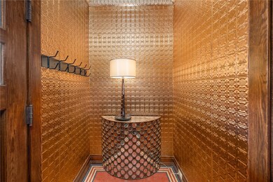 Mosaic ceramic tile floors, natural woodwork and t