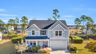 View of front of property with a front lawn and a garage