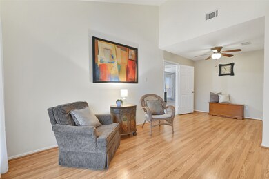 Just off of the left side of the foyer, this flexible-use space could serve as a dining room, a study, a playroom, or a 4th bedroom. It features a soaring vaulted ceiling with a lighted ceiling fan, a front-facing window, and a door for direct access to the kitchen.