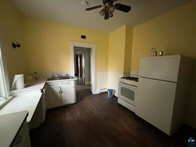 Kitchen with white appliances, white cabinets, cei