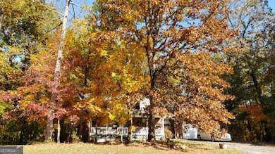 Front of the home with fall trees in bloom