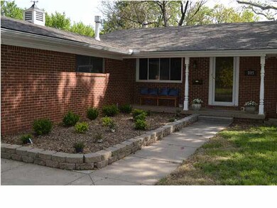 Landscaped walkway leading to comfortable front po