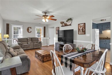 Living room with sink, light wood-type flooring, a