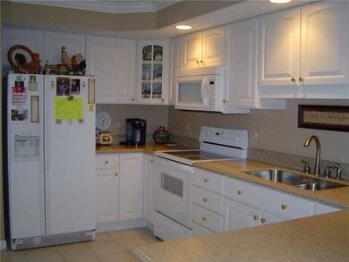 Bright kitchen also has recessed lighting and plen