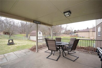 Roof covered concrete patio right off of the kitch