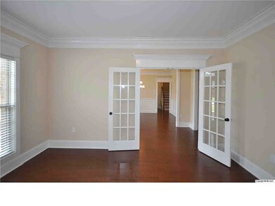 STUDY OFFERS FRENCH DOORS, CROWN MOULDING AND PEDIMENT ACCENTS.