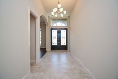 The gentle elegance of the home is enhanced by color scheme and structure in the main hallway/foyer.
