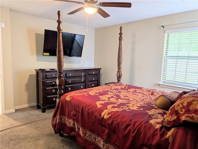 Bedroom featuring carpet and a ceiling fan