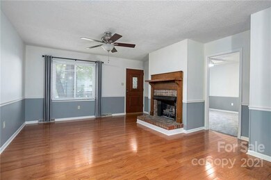 Gleaming Wood Floors and Ceiling Fan In the Living