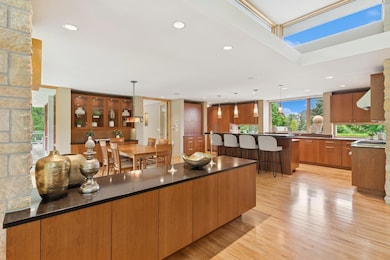 An abundance of custom cabinetry seem to hover effortlessly above gleaming real hardwood floors. Subzero, new dual Asko's & Wolf are here to serve your Chef & great nature views reward culinary goals. A walk-in pantry is out of view by day guests.