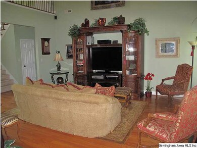 Great room with tall vaulted ceiling features a fi