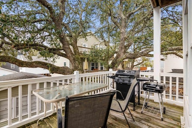 Wooden deck with outdoor dining area and a grill