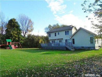 Exterior Back. Large deck in rear.  Play gym has a