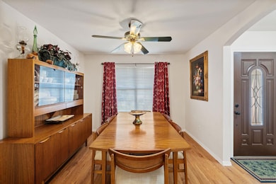 Dining area featuring arched walkways, ceiling fa