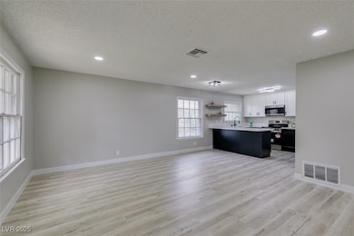 Kitchen with open shelves, stainless steel applian