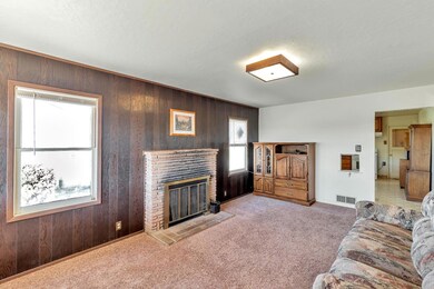Living room with wood burning fireplace.