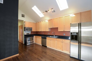 Open kitchen with 42 in cabinets, granite and stai